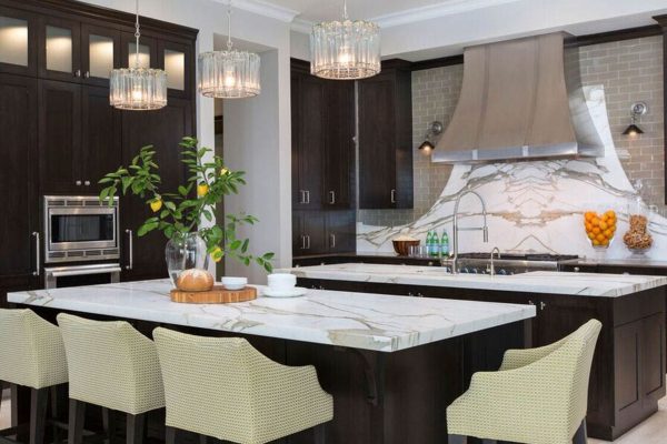 A kitchen with a large island and white cabinets