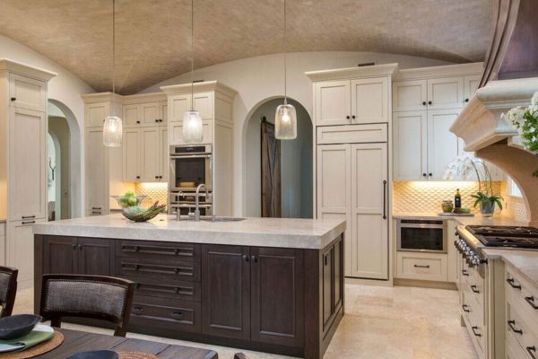 A kitchen with white cabinets and a large island.