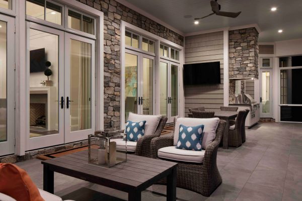 A patio with lots of furniture and a television.