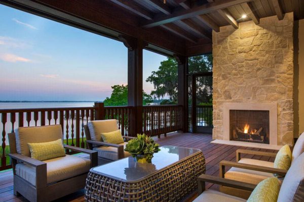 A living room with a fire place and patio furniture.