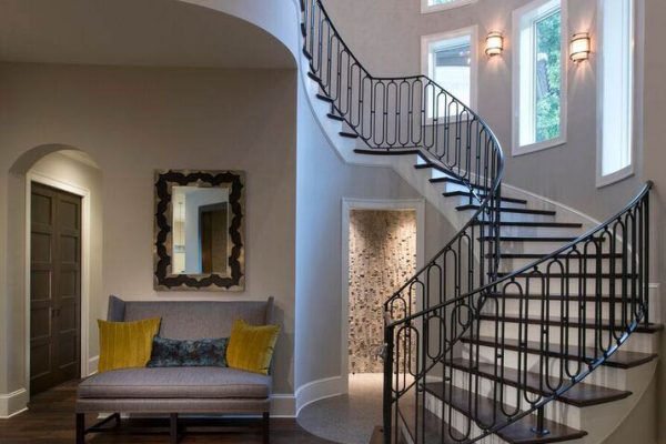 A large staircase with a bench and couch in the middle of it