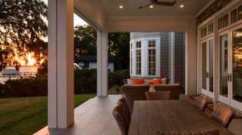 A patio with chairs and tables outside of the house