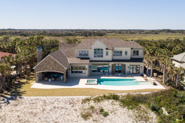 A large house with a pool and an ocean view.